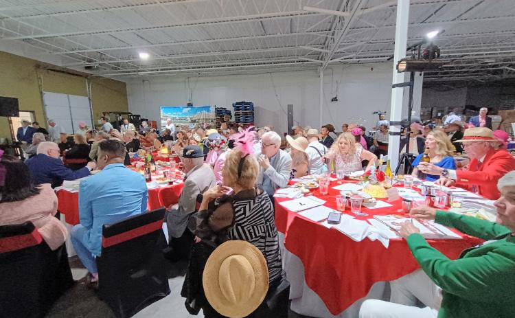 Megan Horn/The Clayton Tribune. Hundreds of people attended the Rotary Club of Clayton Run for the Roses event held at the Food Bank of Northeast Georgia on Saturday, May 3, to help raise money for youth services in Rabun County. The event featured auctions, dancing, dining and dapper attire as well as a live telecast of the 151st Kentucky Derby.