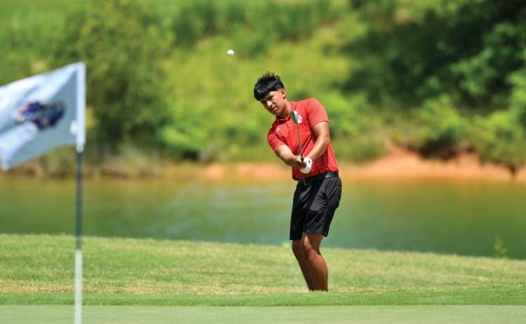 Wade Cheek/The Clayton Tribune. Junior golfer Roberto Diaz chips up onto the green during this week’s Class A-Division I state tournament. Diaz finished seventh as an individual, leading Rabun to an eighth-place finish.