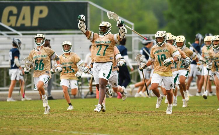 Wade Cheek/The Clayton Tribune. The Rabun Gap-Nacoochee School boys lacrosse team celebrates its quarterfinal victory over Charlotte Latin on Friday, May 9. The Eagles advanced to the semi-final round for the first time in program history.