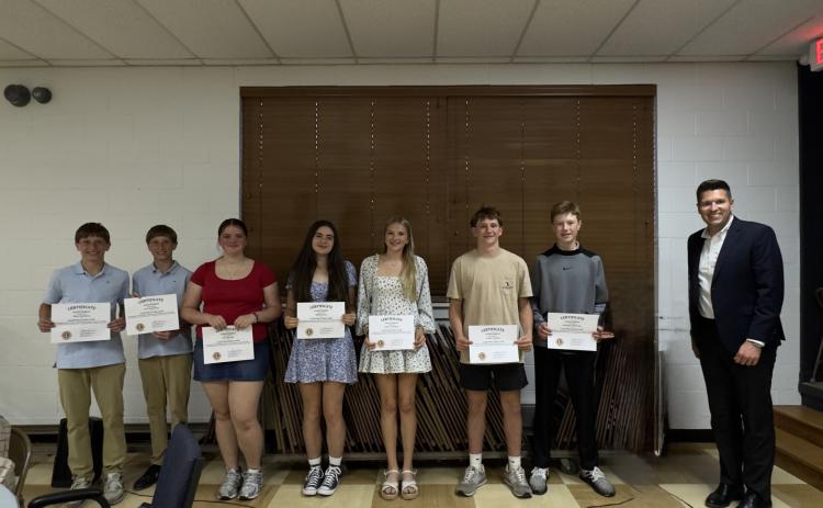 Submitted. Ninth graders honored by the Clayton Lions Club are Silas Stockton (left), Levi Stockton, Ava Sharpe, Mollie Istre, Lydia Gergeni, Colter Cannon and Graham Anderson pictured with Rabun County High School Principal Justin Spillers.