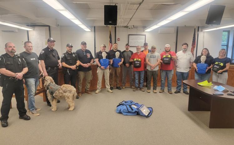 Submitted photo. City of Clayton officials, employees and Clayton Police Department Officers take part in Hands-Only CPR and Automated External Defibrillator (AED) Training at Clayton City Hall on May 14. Rabun County EMS Captain Trampes Stancil instructed and refreshed officials on proper usage. The city recently purchased three AEDs to be used for each patrol shift and have on site.