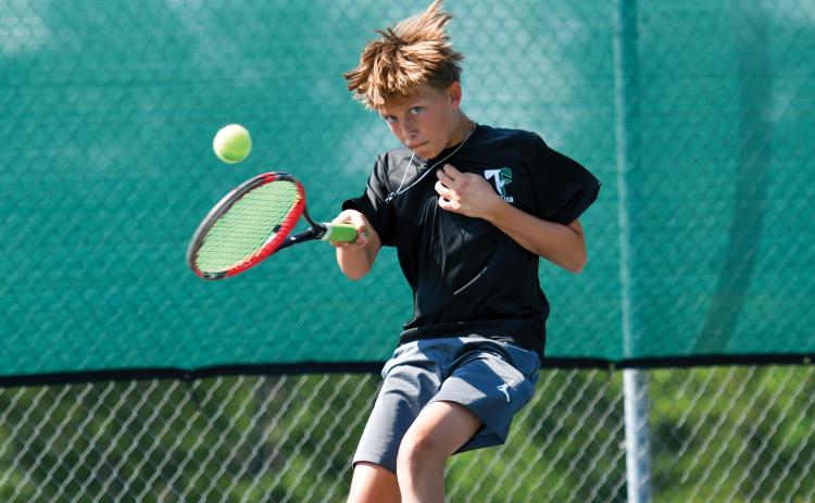 Wade Cheek/The Clayton Tribune. Ethan Alderfer rallies back and forth with his opponent at the Tallulah Falls School kids tennis camp last week.