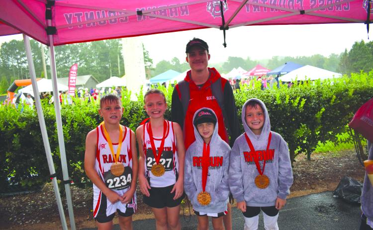 Submitted Photo. From left, top runners Keegan Hanifan-Wagner (10U), Harper Westbrook (10U), Nora Webb (8U), and Owen Moseley (10U) stand with Head Coach Ed Eidson at Athens Christian School on Aug. 23.