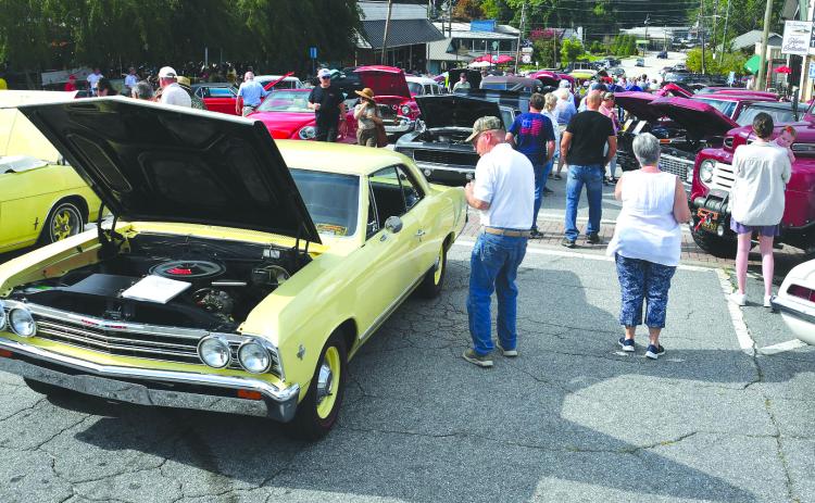 Enoch Autry/The Clayton Tribune. While food trucks were packed in on one end of Main Street in Clayton on Aug. 9, 160 classic vehicles were on hand at the Clayton Block Party for hundreds to check out.