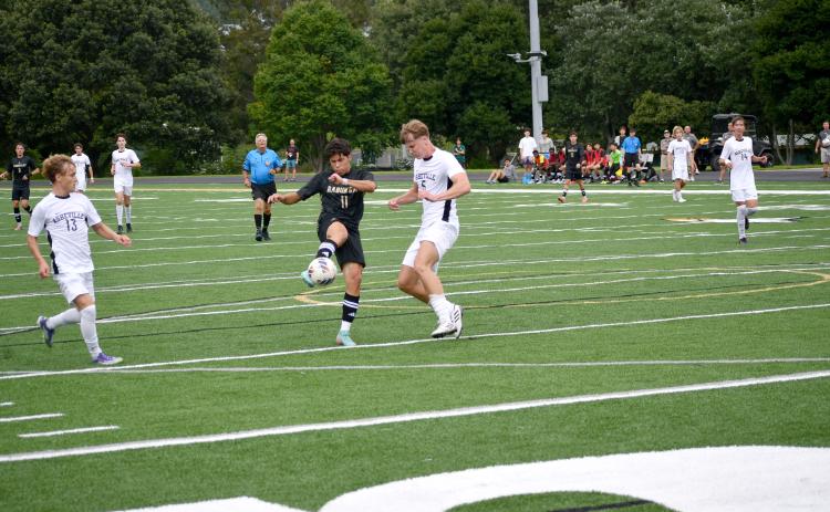 Wesley Branch/TheClayton Tribune. Gabriel Ruelas takes a shot on goal against Asheville High School.