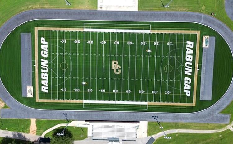 Submitted Photo.  An aerial view shows the newly installed Rabun Gap turf field that was bought through donations to the athletic program. BELOW RIGHT: The RGNS weight room has been expanded with new equipment.