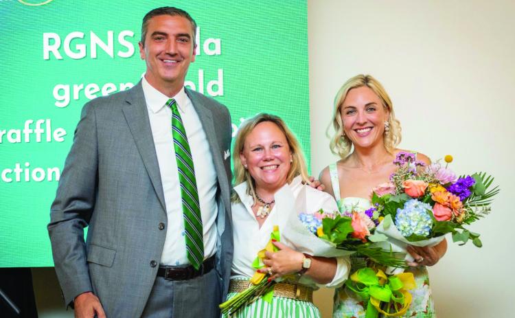 Submitted. Rabun Gap-Nacoochee School celebrated its third annual Green & Gold Gala on Saturday, Aug. 23, at The Dillard House. Pictured, Head of School Jeff Miles recognizes Gala co-chairs and current parents Sarah Barge and Andrea Sorgeloos. The gala raised $260,500 for Rabun Gap students, teachers and programs.