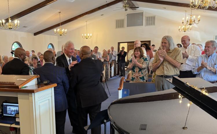 Submitted. letcher Wolfe of Sky Valley greets former members of the Atlanta Boy Choir at Rabun Gap Presbyterian Church at a Sunday concert. Wolfe founded and directed the choir for 60 years.