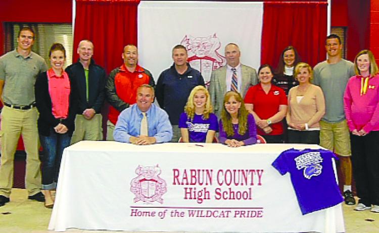 Submitted Photo. Rabun County’s Sally Woerner (seated, center) is surrounded by family and friends as she signs a national letter of intent to play at Western Carolina University.