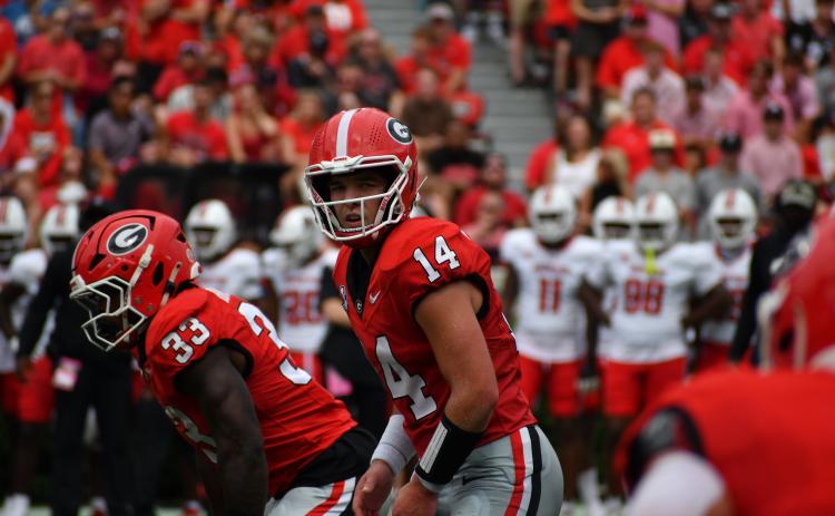 Wesley Branch/The Clayton Tribune. Former RCHS and current UGA quarterback Gunner Stockton prepares to take a snap versus Austin Peay on Sept. 6.