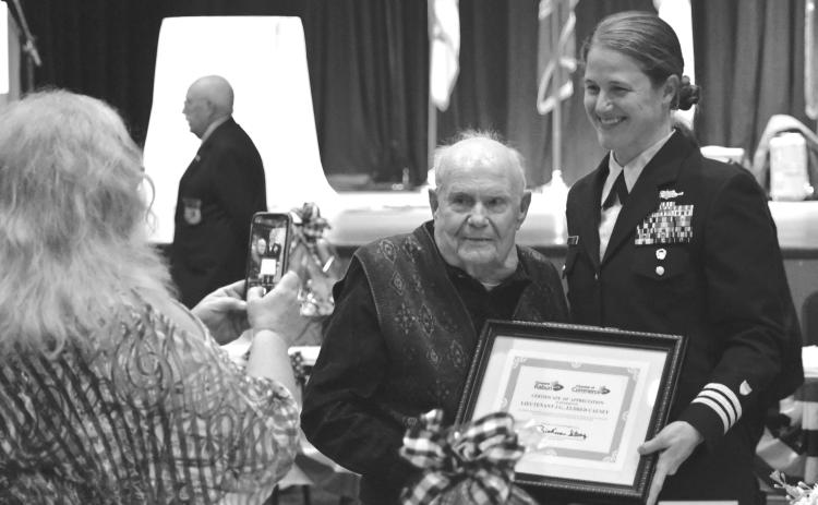 File photo. Enoch Autry/The Clayton Tribune, Kathy Causey takes a photograph of her father Eldrid Causey with Commander Sarah Ernst at the conclusion of the 24th Annual Veterans Appreciation Dinner on Nov. 9, 2023, at the Rabun County Civic Center. Ernst told the audience about Causey, then 99, who served in WWII and was the oldest veteran at the event. Causey, a Rabun County resident, died on Sept. 5, 2025, at the age of 101.