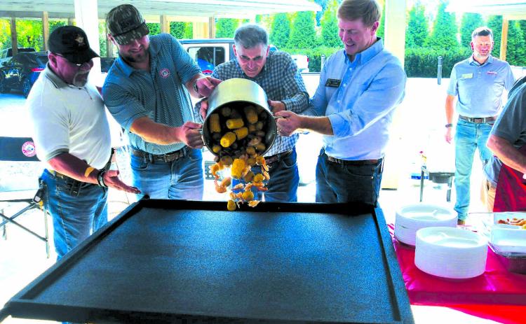 Enoch Autry/The Clayton Tribune. Rabun County Sheriff Mark Gerrills, State Sen. Bo Hatchett, U.S. Congressman Andrew Clyde and State Sen. Blake Tillery, who is running for lieutenant governor pour a pot of low country boil onto a table for the Sept. 13 meal to begin at the Civic Center Pavilions at 201 West Savannah St., Clayton. Republicans seeking seats in the 2026 election spoke to the 9th District gathering on Saturday evening.