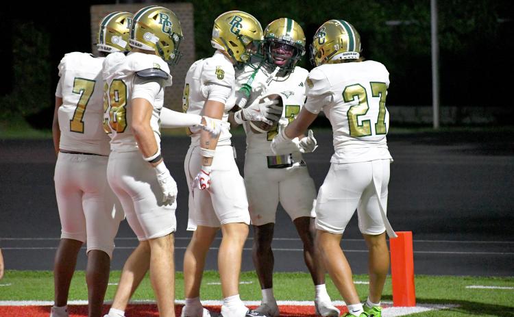 Wesley Branch/The Clayton Tribune. Rabun Gap players swarm teammate Joshua Buckhalter in celebration after Buckhalter’s punt return for a touchdown against Baylor on Aug. 29. The visiting Eagles would fall to the Red Raiders 35-34.