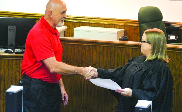 Enoch Autry/The Clayton Tribune. Newly sworn-in Mayor Roy Quilliams shakes the hand of Probate Court Judge Savannah Dixon after he took the oath on Tuesday.