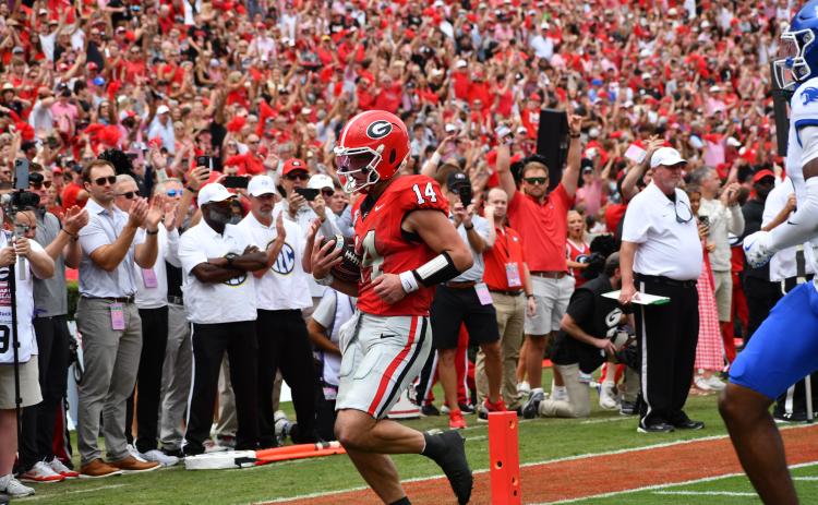 Wesley Branch/The Clayton Tribune. Georgia quarterback Gunner Stockton takes it into the end zone against Kentucky a touchdown run in the Bulldogs’ 35-14 win over Kentucky on Oct. 4. Former Rabun County standout whose high school No. 14 jersey has been retired, Stockton finished with three total touchdowns for UGA, including two rushing.