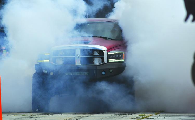 Enoch Autry/The Clayton Tribune. The Clayton Police Department hosted an event to get Christmas toys for underprivileged children and the Oct. 11 car show/burnout event was successful. Austin Shook’s Dodge Mega 3500 (above) was the first-ever burnout contest winner. See more on page A6.