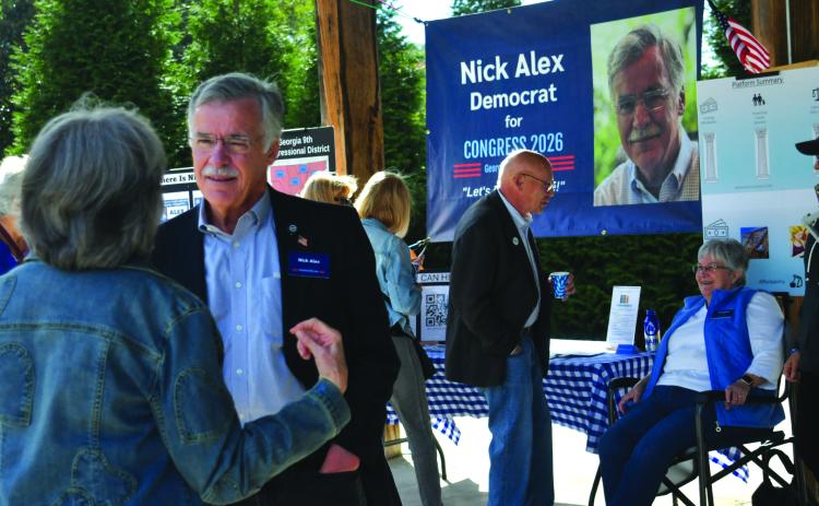 Enoch Autry/The Clayton Tribune. In the foreground, Rabun Countian Nick Alex has a conversation with individuals at the Democratic Party’s 9th Congressional District Blue BBQ in Cllayton on Oct. 11.