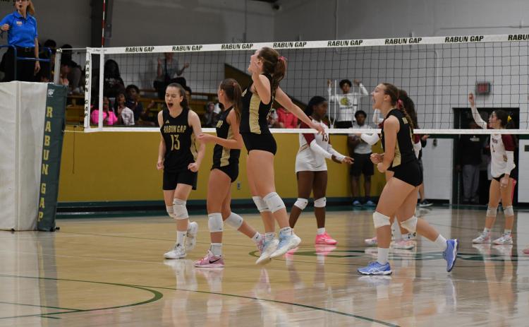 Wesley Branch/The Clayton Tribune. Rabun Gap players celebrate after a 3-2 playoff victory over Cannon on Oct. 10. The win marked the first playoff win for head volleyball coach Zoe Kennedy, and the Eagles’ senior class.