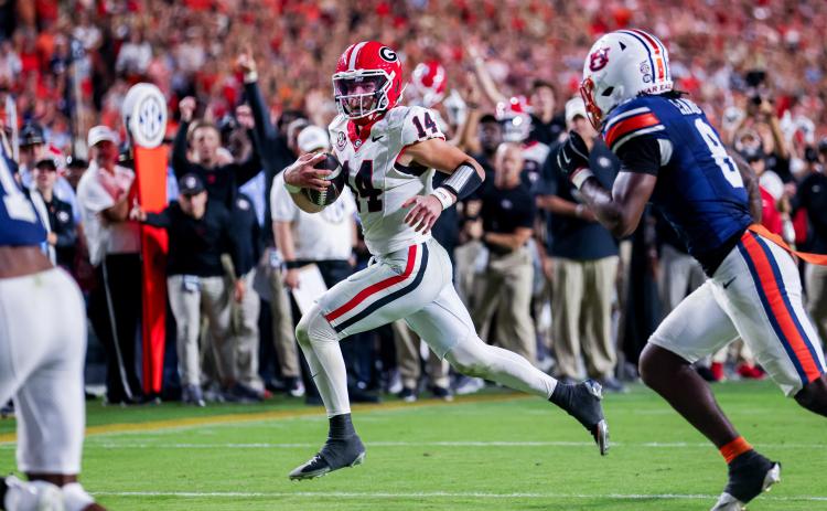 Conor Dillon/UGAAA. Current Georgia and former Rabun County quarterback Gunner Stockton runs versus Auburn in the Bulldogs’ 20-10 road win over the Tigers on Oct. 11. The win was the ninth-straight victory for Georgia over Auburn.