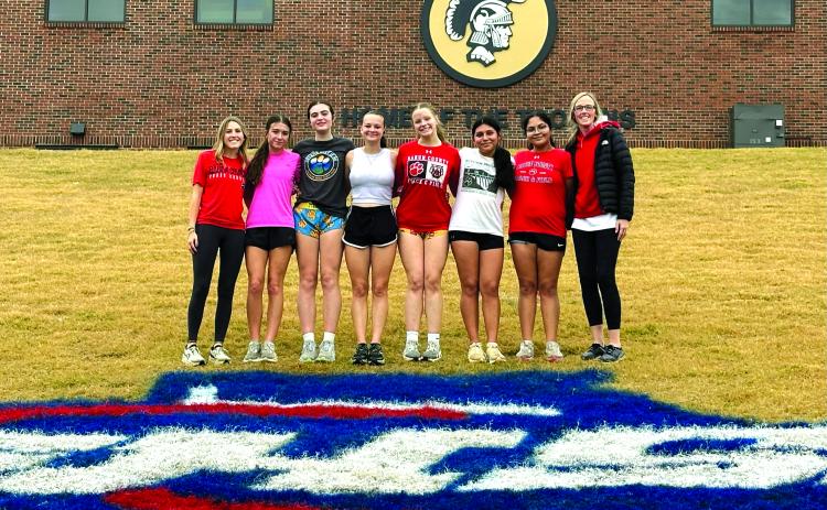 Submitted. The Lady Cats pose for a team photo with head coach April Adcock before the Nov. 8 race.
