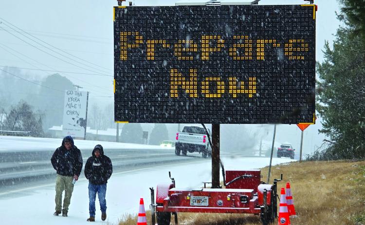 Enoch Autry/The Clayton Tribune. As pedestrians walk along U.S. Hwy. 441 in January 2025, motorists are warned about Winter Storm Cora’s arrival that blanketed Rabun County earlier this year.