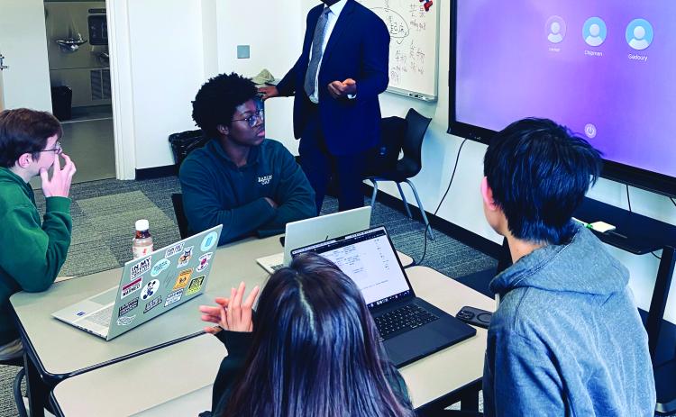 Submitted Photo. Rabun Gap-Nacoochee School teacher Dr. Mason West instructs his AP Economics class. West’s students will present their “Learner Snapshot” app to members of 1 Million Cups at a Dec. 10 meeting at the school.