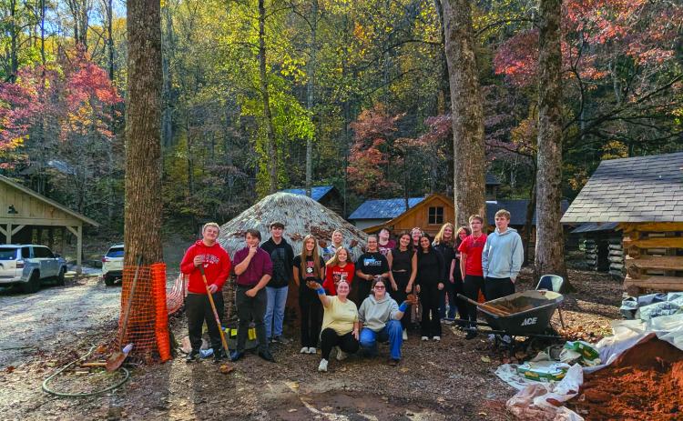 Submitted Photo. The full RCHS group poses for a photograph at Cherokee mud house on the Foxfire Museum property.