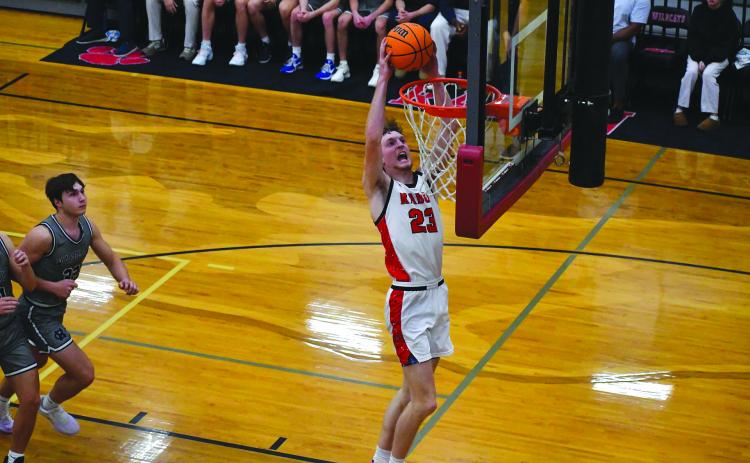Rabun County senior forward Hayes Free finishes an alley-oop from senior point guard Huey Blalock in Rabun County’s home-opening 83-66 win over White County. Hayes was a preseason All-State selection.