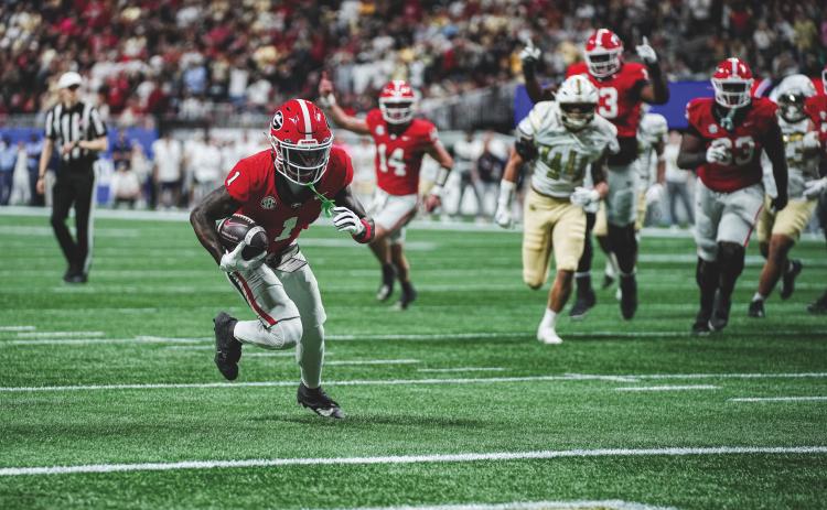 Tony Walsh/UGAAA. Georgia wide receiver Zachariah Branch runs to the end zone for a receiving touchdown in Georgia’s 16-9 win over Georgia Tech on Nov. 28. In the background is former Rabun County and current Georgia quarterback Gunner Stockton. Stockton and Branch connected for the only TD scored in the game.