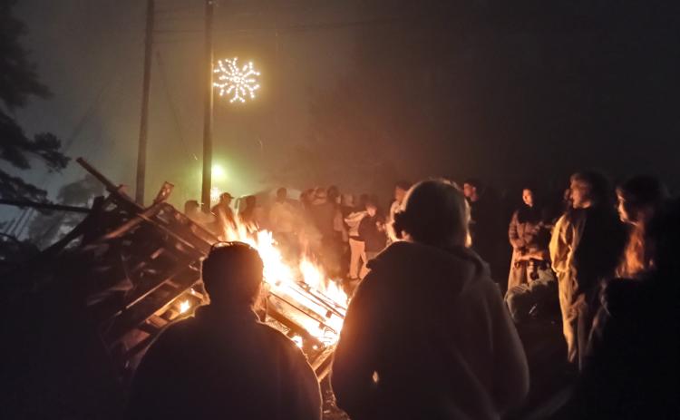 Megan Horn/The Clayton Tribune. Tallulah Falls community members and students at Tallulah Falls School kicked off the holiday season with its annual Town Christmas Party on Friday, Dec. 5. Unique to Tallulah Falls was a giant bonfire that lit up the night sky and warmed eventgoers on a chilly evening.