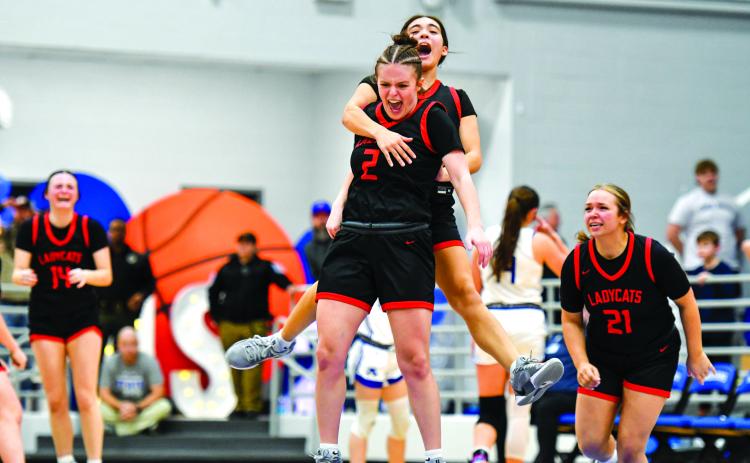 File/Wade Cheek/The Clayton Tribune. Rabun County’s Adelyn Thompson celebrates with Addy Beth Owens after knocking down the game-winning shot against Armuchee High School in the first round of the state playoffs last season. The Lady Wildcats advanced to the Elite Eight for the 10th time in history.