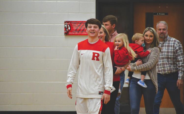 Wesley Branch/The Clayton Tribune. Rabun County senior Huey Blalock is escorted by his family on Senior Night against Towns County. Blalock recently announced his verbal commitment to continue his playing career at the Naval Academy.