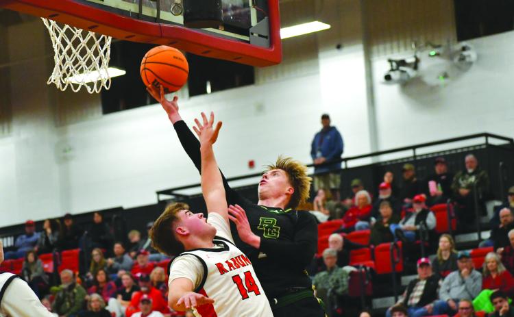 Wesley Branch/The Clayton Tribune. abun Gap junior Joonatan Tartu shoots over Rabun County freshman Cord Burrell for a contested layup against Rabun County on Dec. 19. Rabun County took the win 64-59, improving to 9-1 while Rabun Gap fell to 10-5.