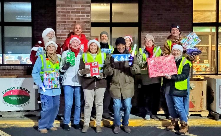Megan Horn/The Clayton Tribune. Volunteers at the Dec. 16 Food Bank of Northeast Georgia toy drive include James Brim, director of the Food Bank of Northeast Georgia Mountain Branch; Donna Long; Herman Bunn; Renee Ramsay; Stan Vik; Janet Vik; Cherye Weintraub; Stephen Weintraub; Beth Nelson; Mark Shryock; Brenda Cook; and even Santa Claus himself!