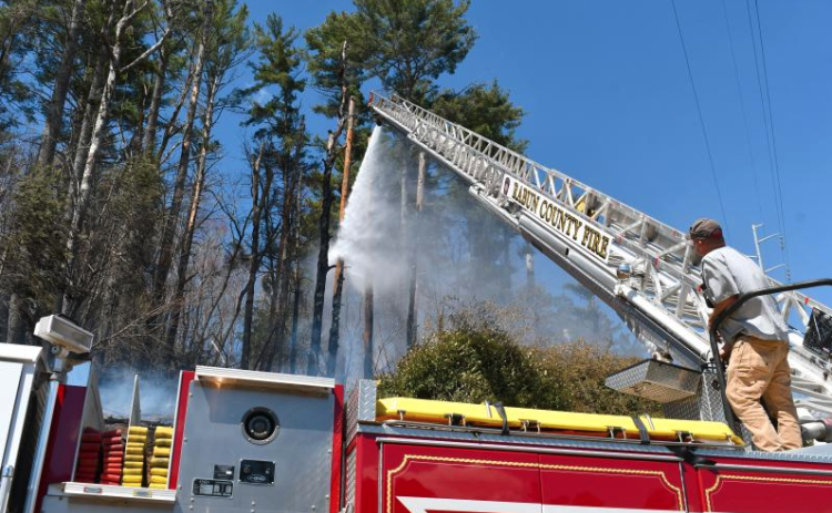 File/Megan Horn/The Clayton Tribune. Josh Bleckley, Rabun County Fire Services Station 2 Captain, operates Ladder 1 for a brush fire on Clayburne Street in Clayton on March 25. This happened around the same time as United States Department of Agriculture (USDA) Forest Service crews battled a fire burning in the Warwoman Wildlife Management Area between Sarah’s Creek and Walnut Fork, north of Warwoman Creek in Rabun County.