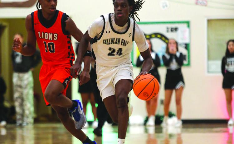 Photo courtesy Audrey Borchers. Brian Neely pushes the ball up the court in TFS’s 75-33 road win over Riverside Military Academy on Jan. 13. The Indians are ranked third.
