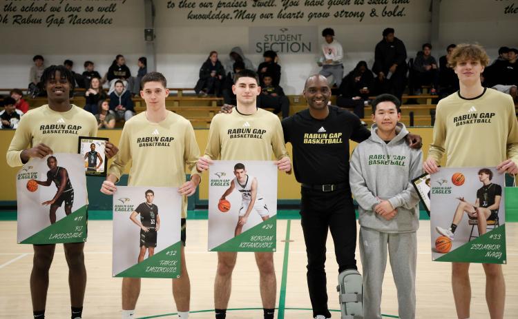 Photo courtesy Rabun Gap Athletics. Rabun Gap basketball seniors pose for a picture with first-year head coach Devin Liferidge (center) ahead of the Eagles’ 59-46 win over Asheville School on Feb. 7. The Eagles are 16-9 on the season with two games remaining before the state playoffs.
