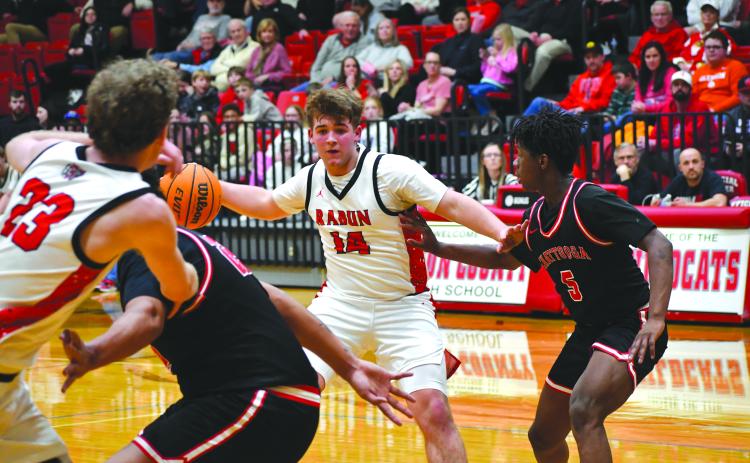 Wesley Branch/The Clayton Tribune. Rabun County freshman Cord Burrell sets up senior Hayes Free with a backdoor pass in Rabun County’s 80-47 first round playoff win over Chattooga on Feb. 24.