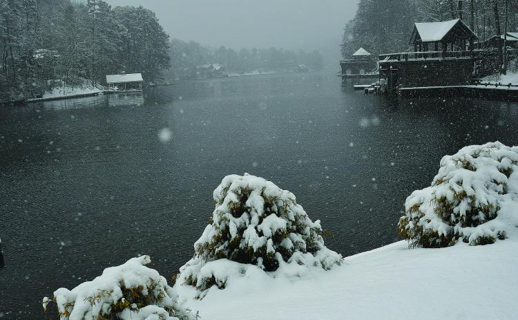 Enoch Autry/The Clayton Tribune. Large and small flakes float down onto Lake Burton at Perrin Cove Saturday morning as Rabun County receives an excess of 7 inches of snow.