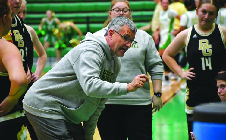 Wesley Branch/The Clayton Tribune. Rabun Gap head girls basketball coach Dale Earnhardt directs his team during a timeout in its Jan. 30 game against Buford. Earnhardt recently notched his 450th career victory as a head basketball coach.
