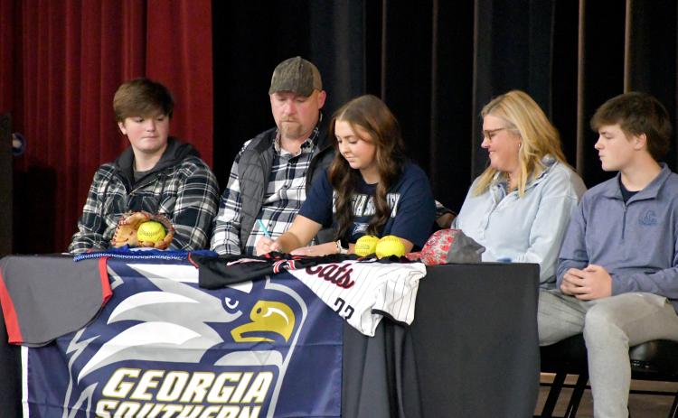 Wesley Branch/The Clayton Tribune. Rabun County softball senior Presley Burrell signs her letter of intent to Georgia Southern University East Georgia while accompanied by her family on Rabun County’s campus on Feb. 5. Burrell earned All-Region second-team honors in her senior season.