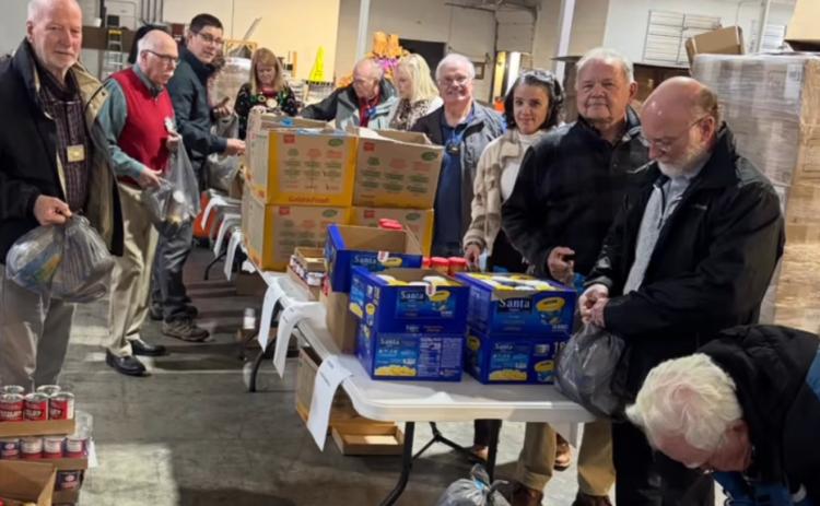 Photo courtesy of the Rotary Club of Clayton. Rotarians pack lunches for those in need at the Food Bank of Northeast Georgia. The service project is ongoing and part of many projects to benefit the Rabun County community. Service has been the focus of the organization, with Rotary members and Impact Club participants volunteering.