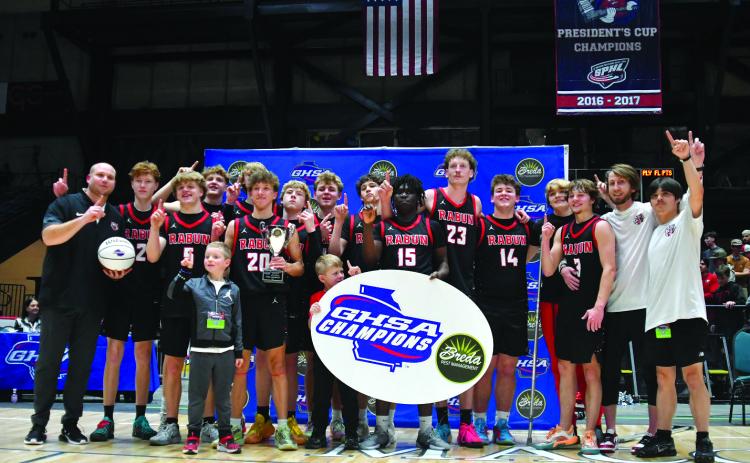 Enoch Autry/The Clayton Tribune. The Rabun County boys basketball team poses after its 52-43 state championship win versus Southwest on March 13 at the Macon Coliseum. The Wildcats set a school record with 30 wins and secured their first state title this season.