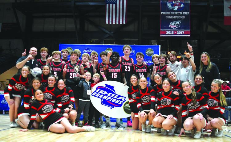 Enoch Autry/The Clayton Tribune. The Rabun County boys basketball team and RCHS cheerleaders pose for a photo after the basketball team's 52-43 state championship victory versus Southwest on March 13 at the Macon Coliseum