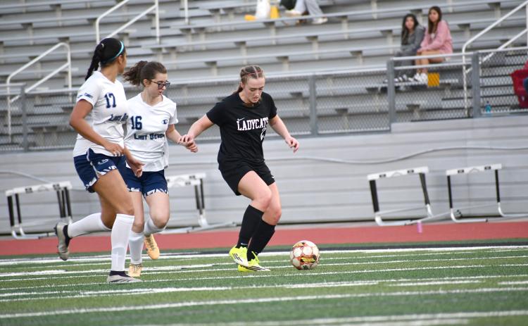 Wesley Branch/The Clayton Tribune. Rabun County freshman Millie Southards fights off Elbert County defenders in Rabun County’s 9-1 win over Elbert County on March 6 at home. Southards scored three goals in the win.