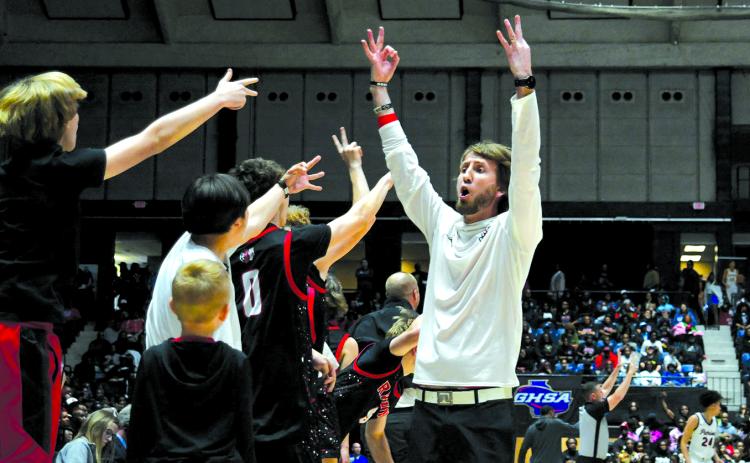 Enoch Autry/The Clayton Tribune. Rabun County boys basketball head coach David Adcock and his Wildcat bench celebrate a 3-point shot by senior Huey Blalock in the 52-43 win on March 13 for the Class A Division I state championship.