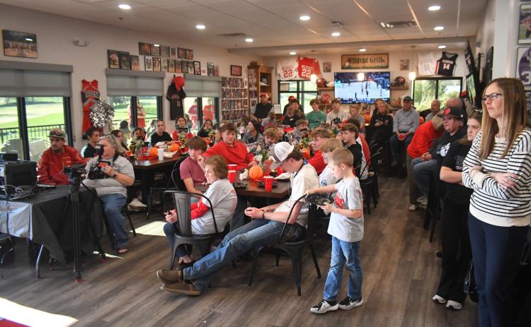 Wesley Branch/The Clayton Tribune. The community packed the Wildcat Grill March 19 for the chance to personally congratulate the RCHS boys basketball team on winning the state title. The event was broadcast live on Wildcat Sports LIVE.