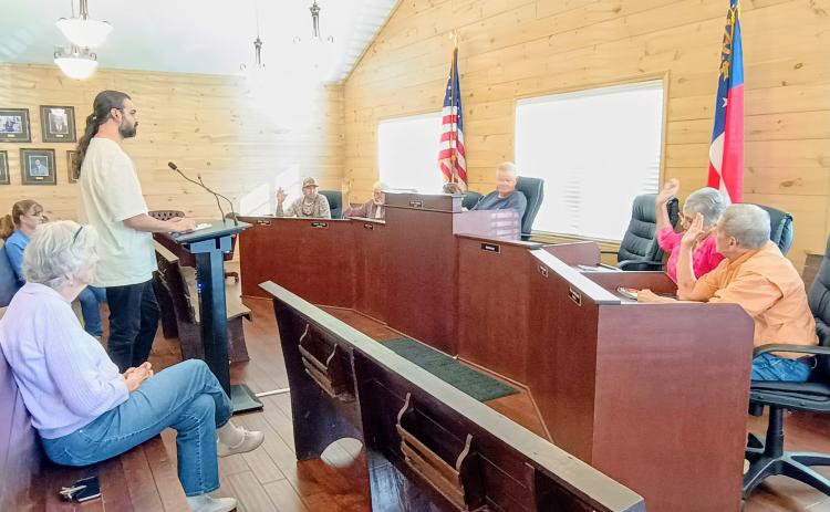 Megan Horn/The Clayton Tribune. Tiger Town council members unanimously vote March 9 to approve a rezoning request from Residential to Commercial at 26 Bridge Creek Rd. in Tiger. The property is adjacent to the Tiger Biscuit Place (BP) General Store. The purpose of the rezoning is to add gas pumps at the Tiger four-way intersection. Pictured center is Alim Dhanani, owner of Tiger BP. The other owner is Aslam Dhanani.