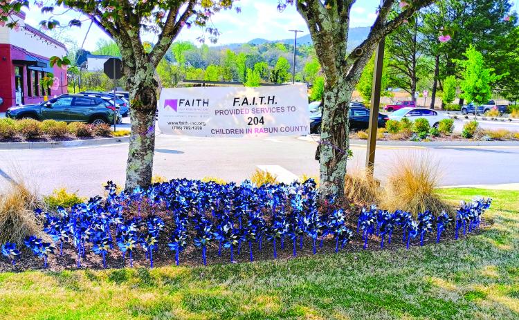 Megan Horn/The Clayton Tribune. Blue pinwheels can be seen spinning at Chick-fil-A Clayton. Each pinwheel represents a child in Rabun County who was helped by local nonprofit Fight Abuse In The Home (F.A.I.T.H.) last year. F.A.I.T.H. provided services to 204 children in Rabun County in 2025. Pinwheels can also be seen at the Rabun County Division of Family and Children Services (DFCS) office. April is Child Abuse Prevention Month.
