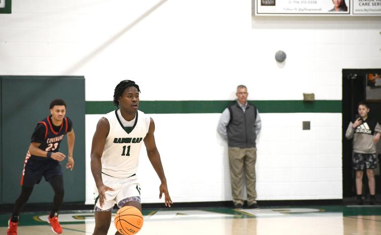 Wesley Branch/The Clayton Tribune. Rabun Gap senior RJ Lacossade races down the floor during Rabun Gap’s 56-49 playoff win over Covenant Day on Feb. 17. Lacossade is just the seventh basketball player from Turks and Caicos to make it to the collegiate level.